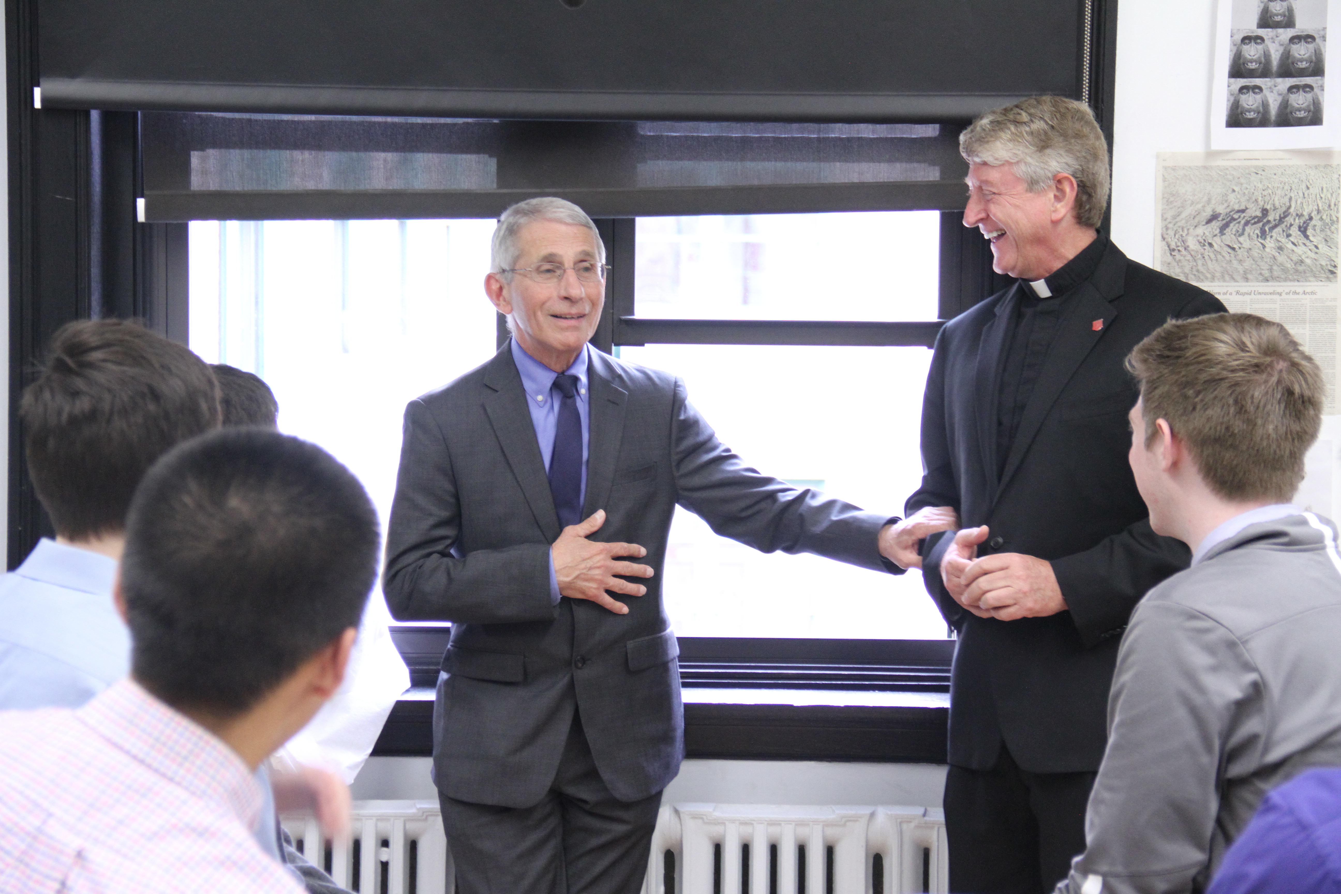Dr. Anthony Fauci meets with New York City's Regis High School students and the school's president, Jesuit Father Daniel Lahart, in 2019