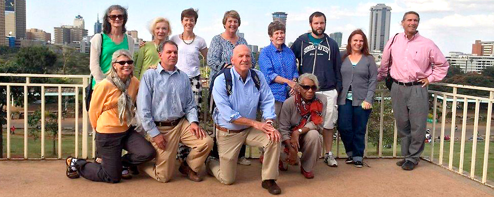 Pilgrims at Uhuru Park overlooking downtown Nairobi. Front row: (left to right) Clare Brichler, Jeff Smart, Mark Maxwell, Diane Patterson Schultz. Back row: (left to right) Gerry Vehr, Camille Devaney, Christine Curran, Patty O’Conor, Maureen Collins, Cian Earls, Denise Hintzke, and Mark Bandsuch, SJ.