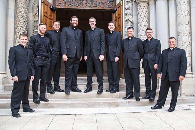 The nine Midwest Jesuits who pronounced first vows at Saint Thomas More Catholic Community in St. Paul: (left to right) James McGivney; Thomas O’Donnell, IV; Pierce Gibson, IV; James Kennedy; Jack McLinden; David Inczauskis; Michael Bartlett; Christopher Williams; and José “Chuy” Camacho