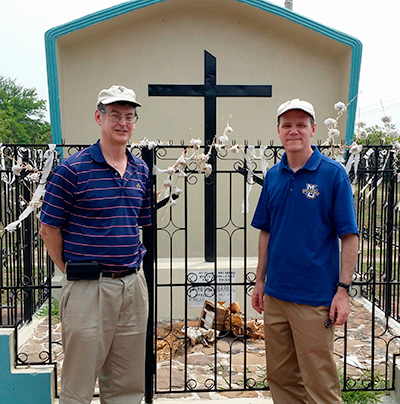 Fr. Brian Paulson, SJ, and Fr. Thomas Lawler, SJ, at a memorial marker for Fr. Rutilio Grande, SJ, who was assassinated by a Salvadoran death squad in 1977