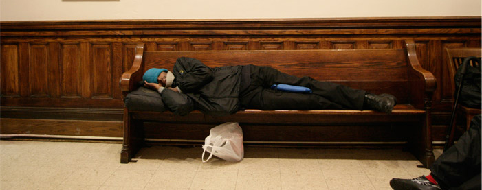 A homeless man rests inside the Warming Center