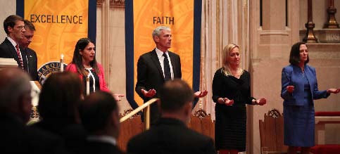 Marquette University president, Dr. Michael Lovell (center), and others joined in prayer at the vigil for James Foley on August 26, 2014, at Church of the Gesu. All 28 Jesuit universities in the US honored what would have been Foley’s 41st birthday on October 18, 2014.